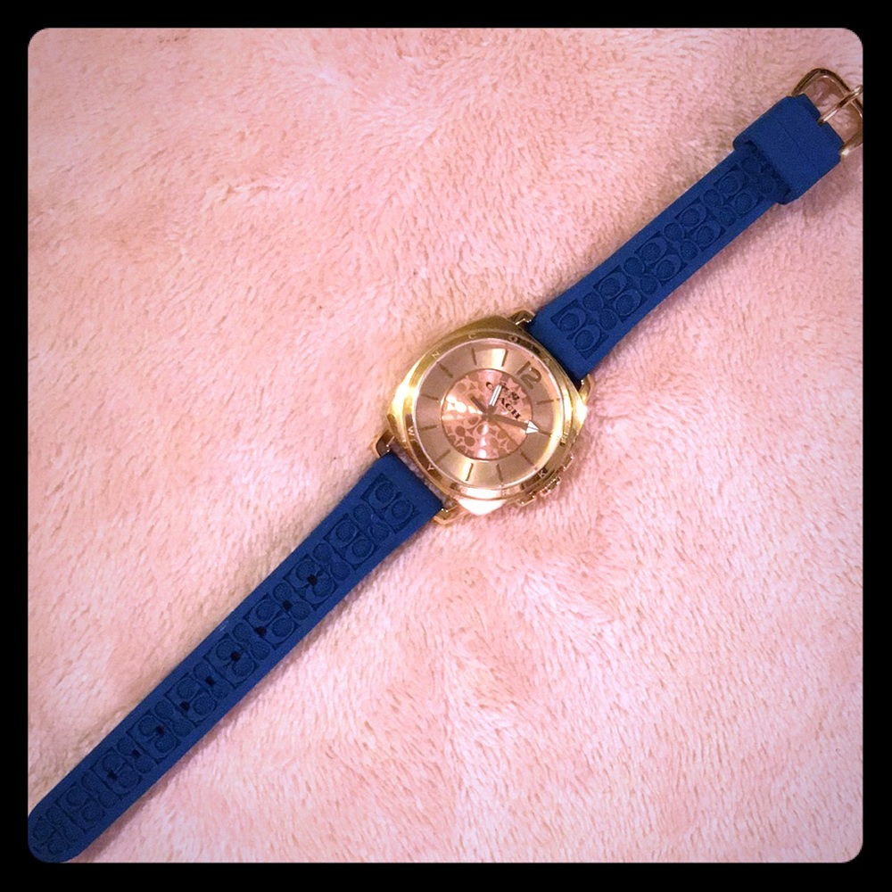 A gold coach watch with a blue (rubber) band.